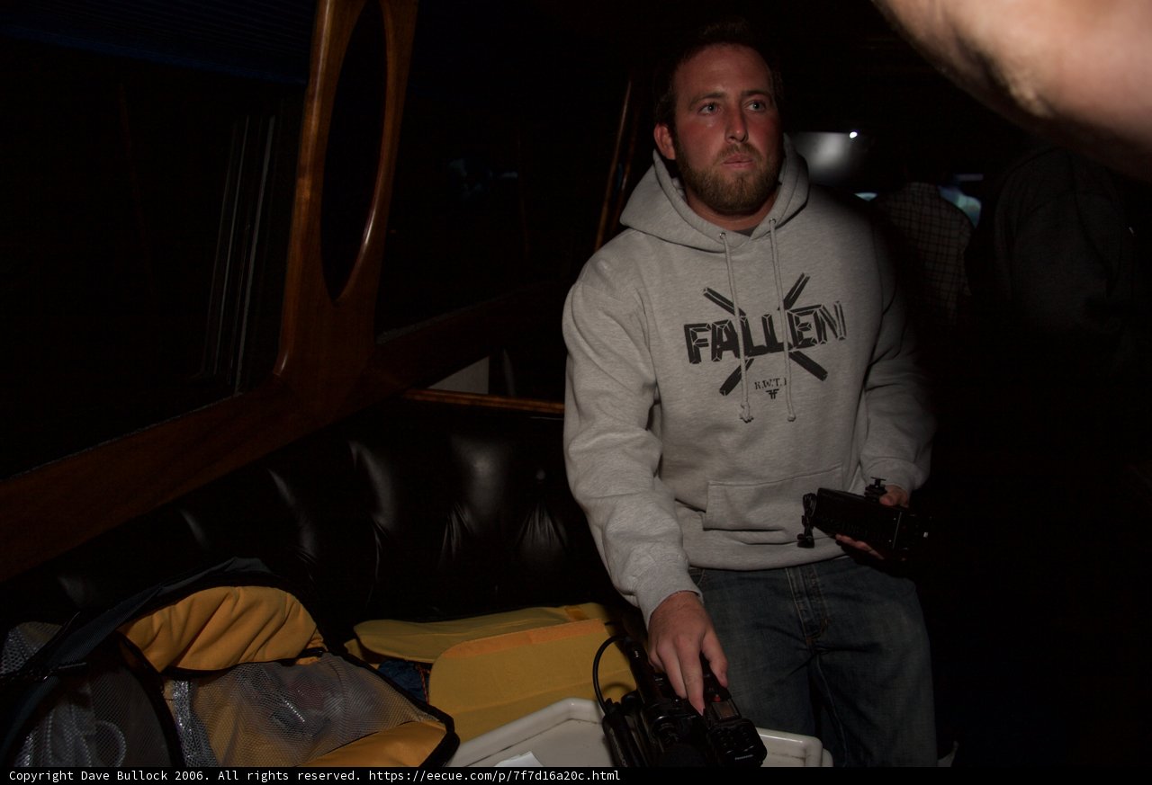 Comfortable in Knitwear: Hoodie-Wearing Man Holds Remote Control