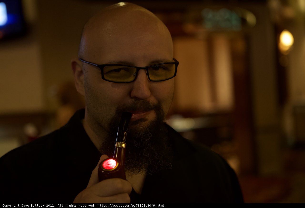 Red-Lighted Pipe in the Hand of a Bearded Man
