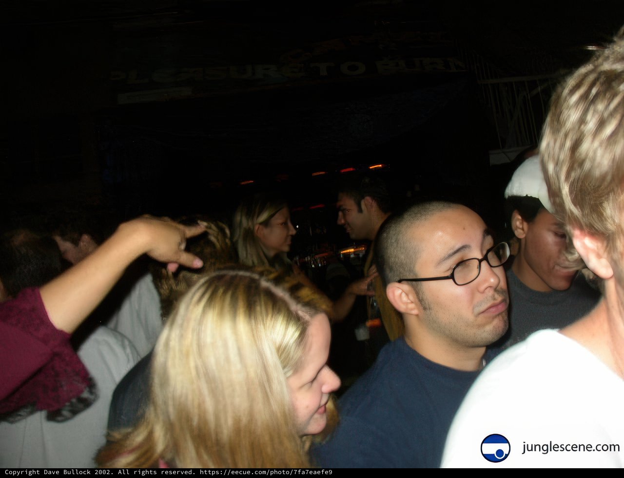 Nightclub Crowd with Man in White Shirt