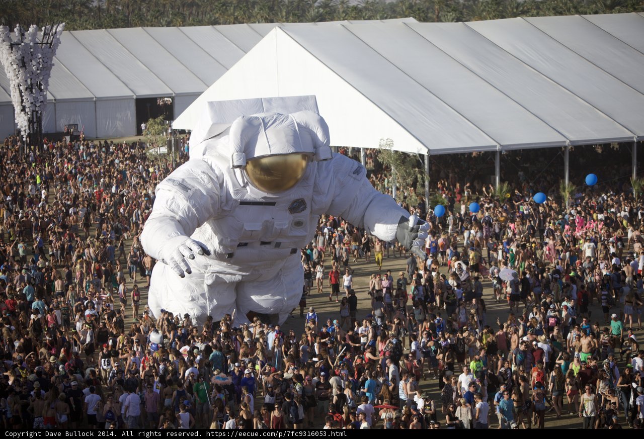 Giant Astronaut Amuses a Sea of People