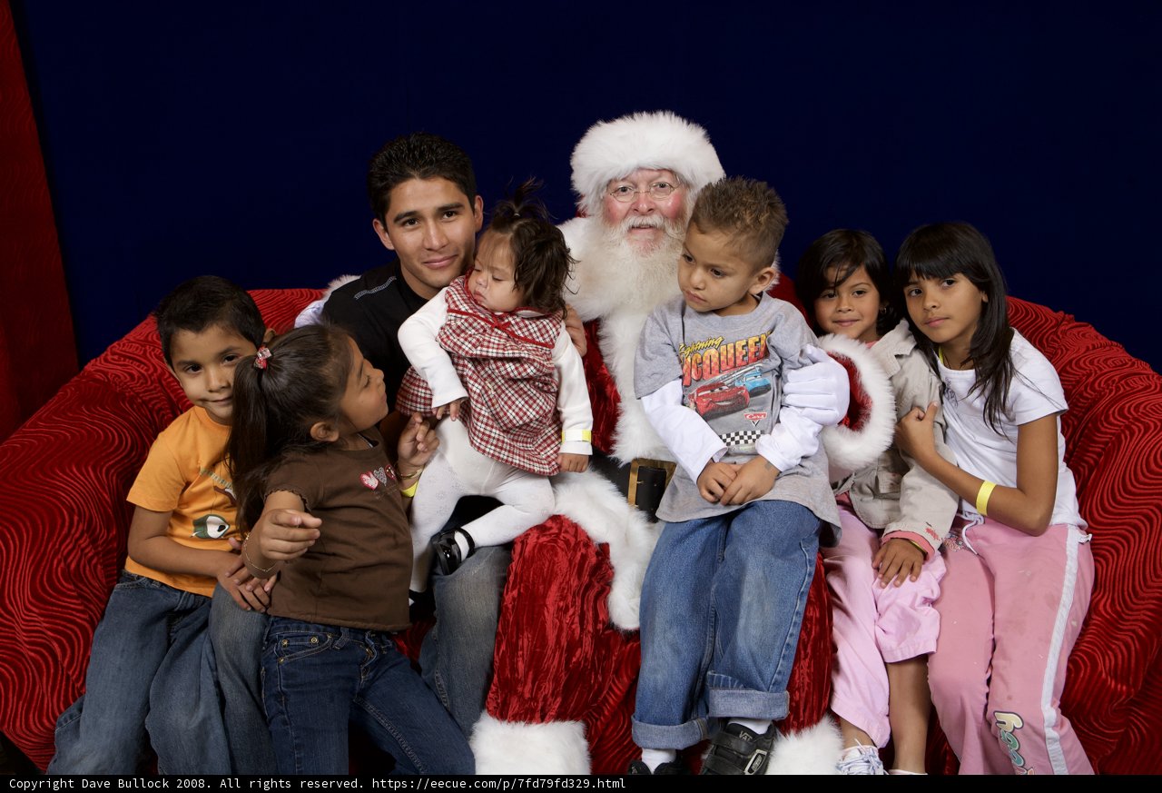 Santa Claus Visits with Excited Children on Christmas Eve
