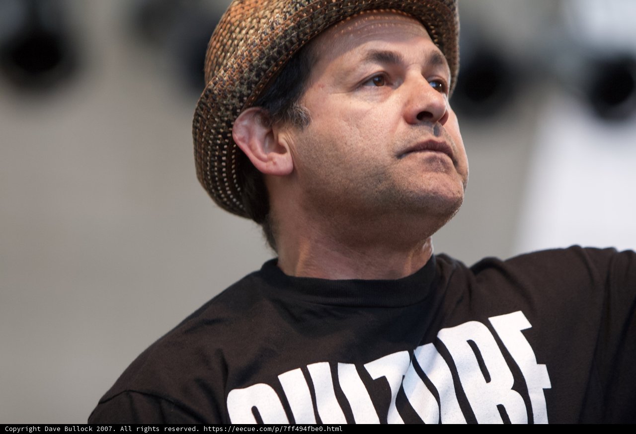Man in a Hat and Shirt at Ozomatli Performance
