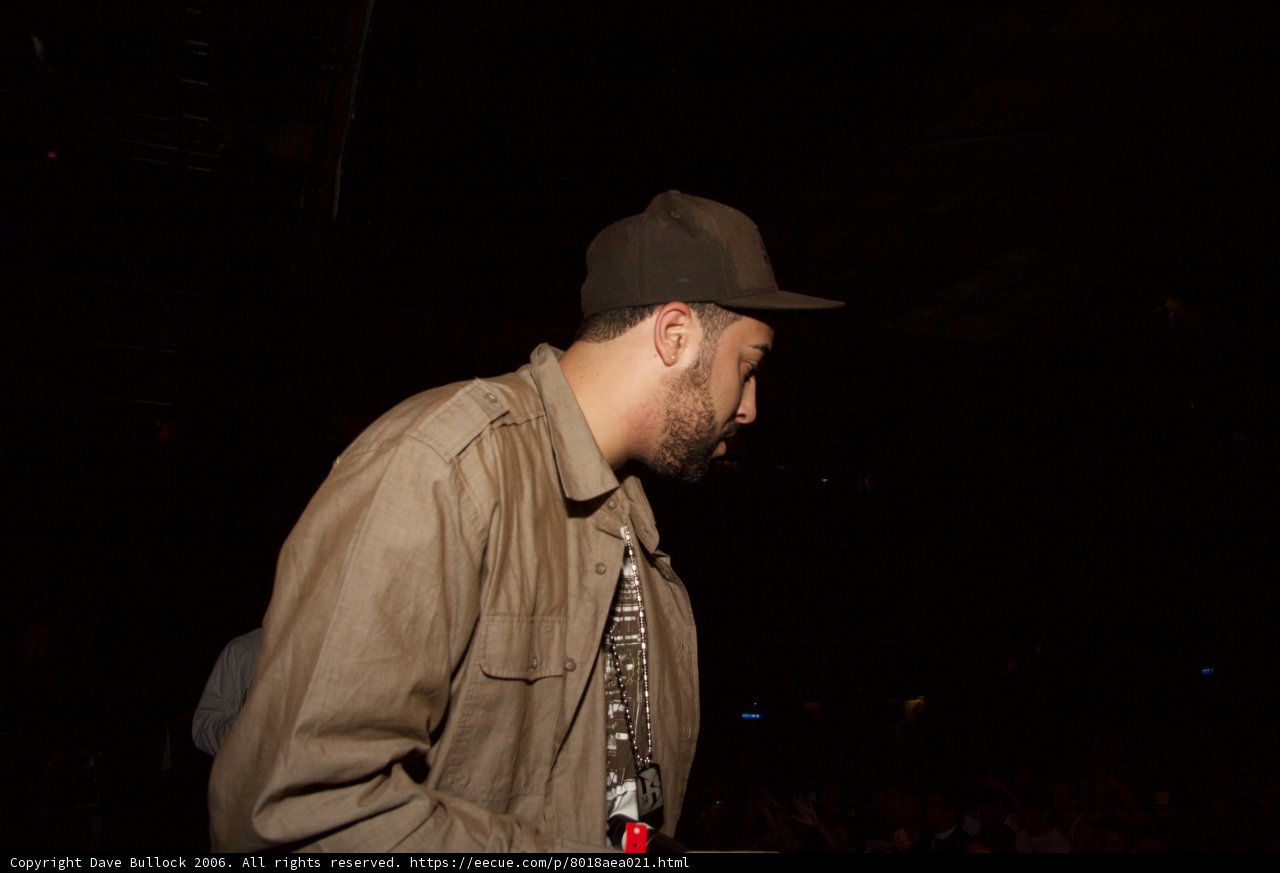 Man in Hat and Jacket Faces the Crowd