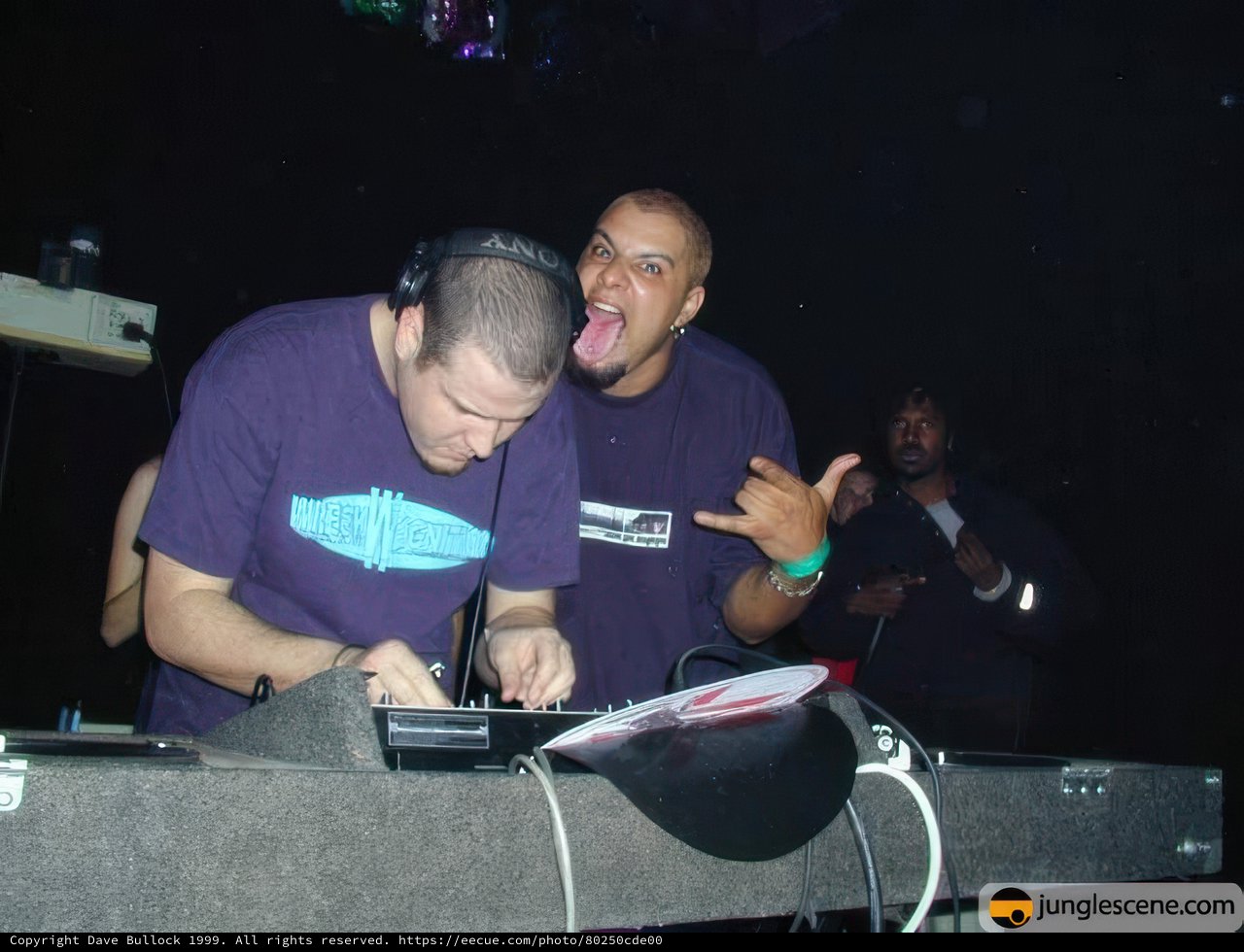 Purple-shirted deejays making music