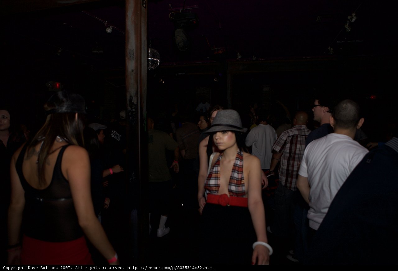 Night club duo in stylish headgear