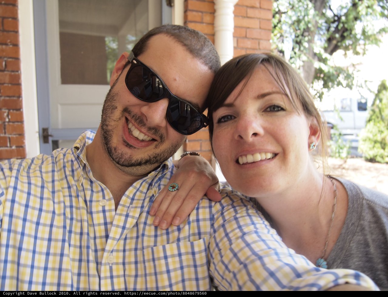 Smiling Couple Poses Together on Sunny Porch