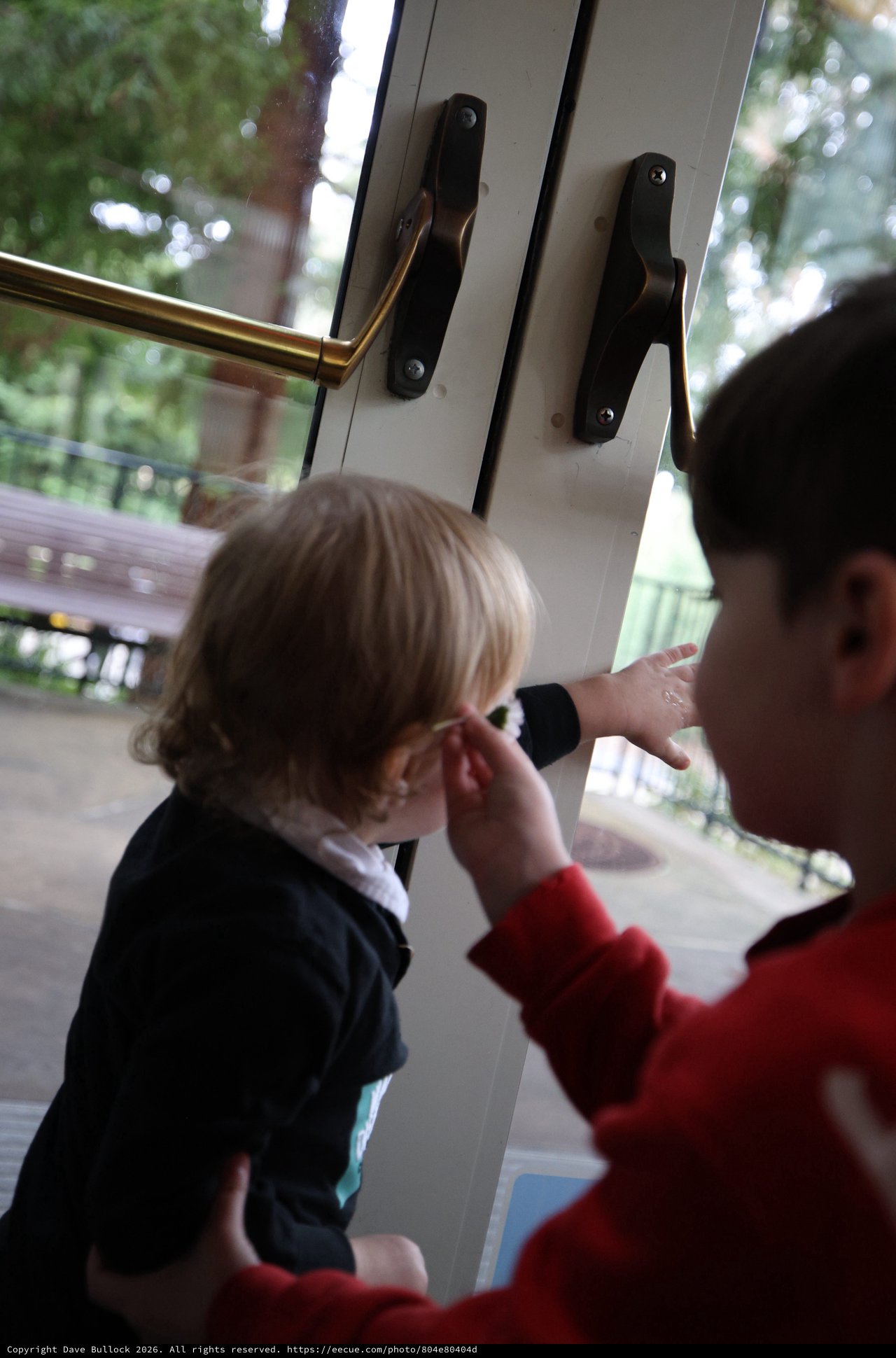 Parent Comforting Young Child by Open Door