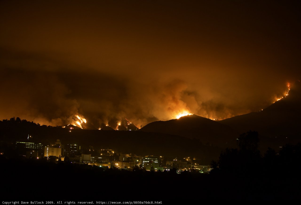 Flames light up the hilltop