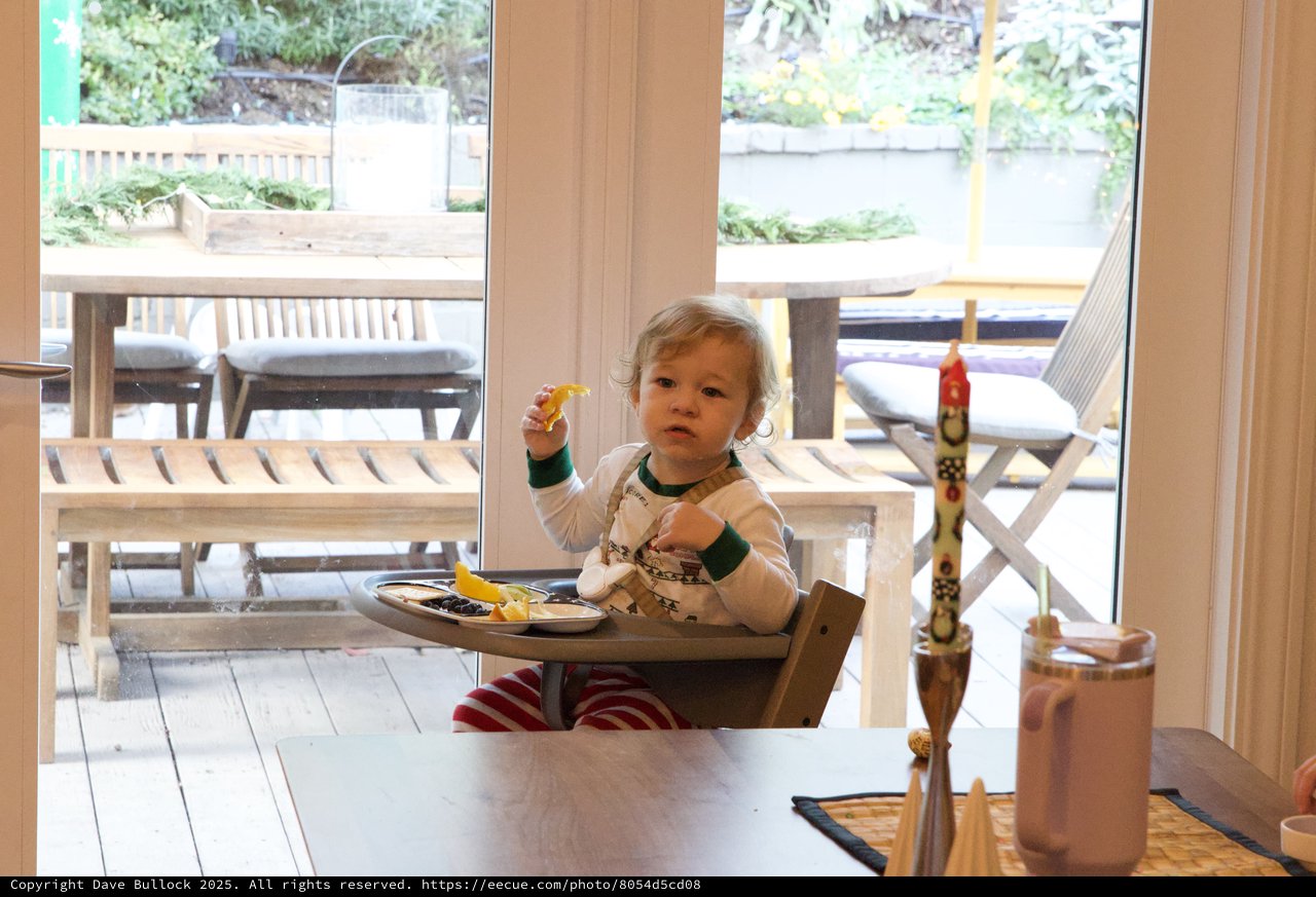 Toddler Enjoying Christmas Eve Breakfast at Home