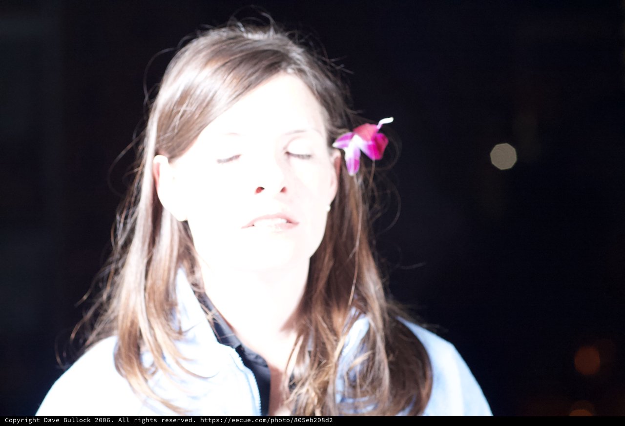 Serene Woman with Pink Flower in Hair