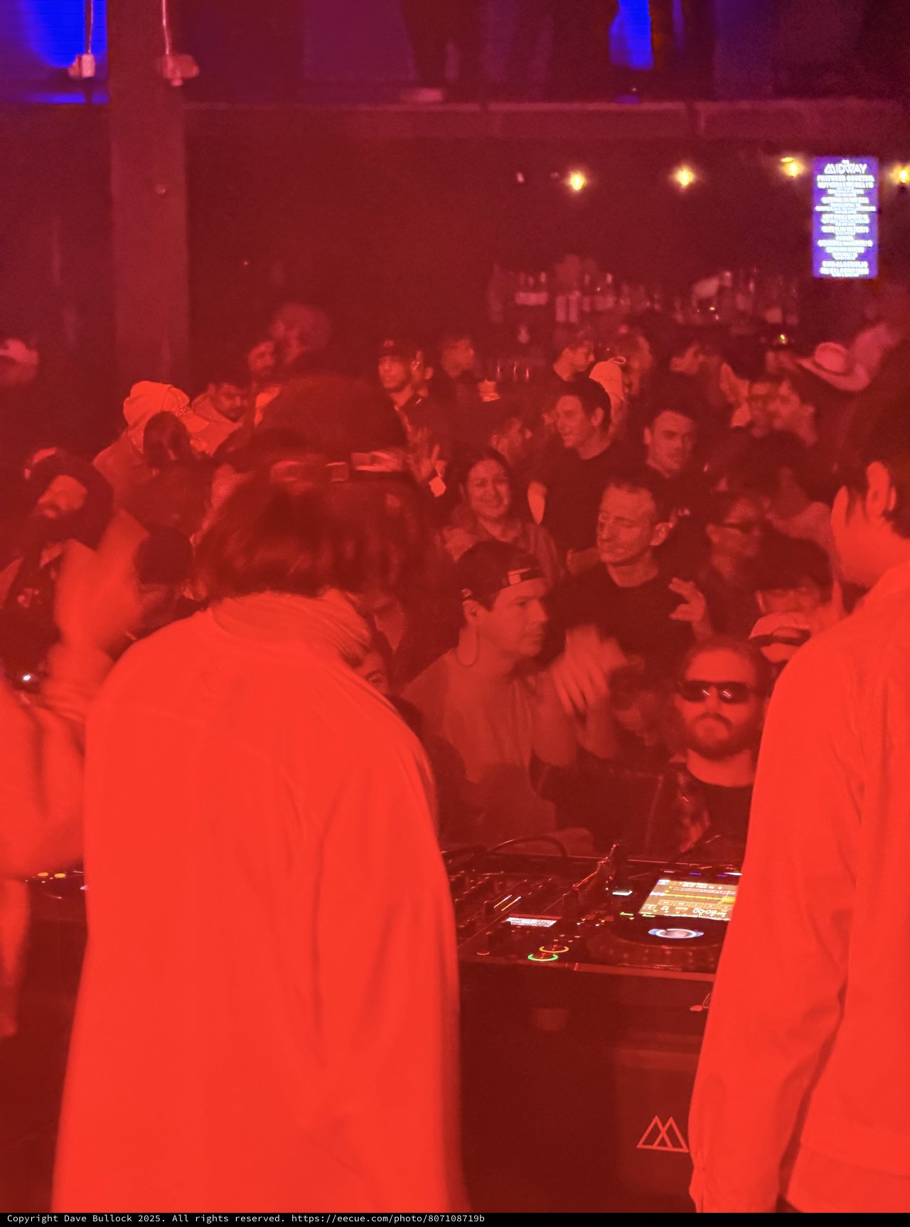 Red-Lit DJ Set at Electronic Music Event