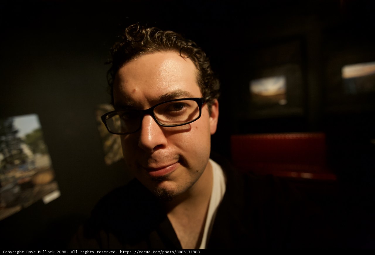 Smiling Man in Black Glasses