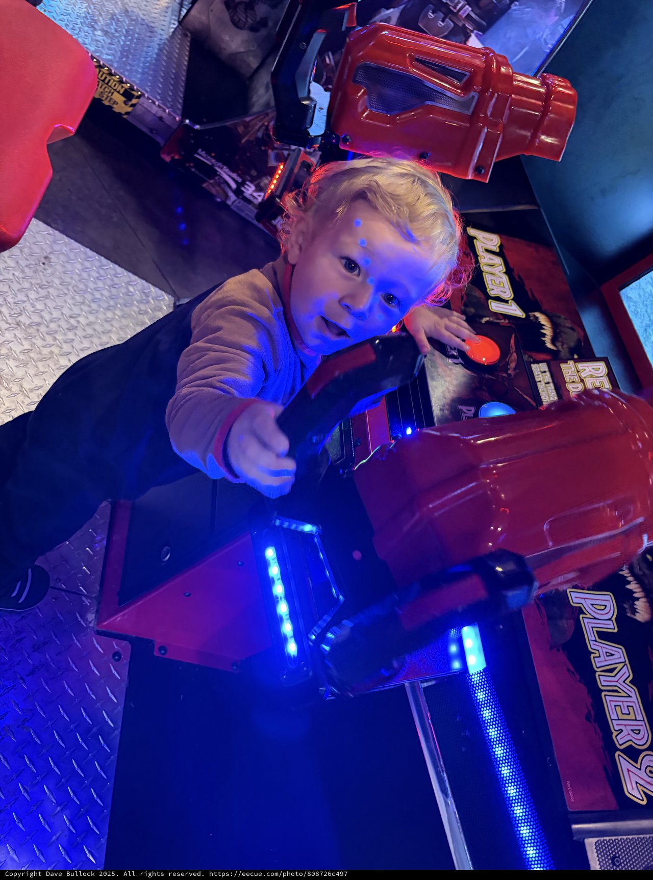 Young Child Playing at Arcade Gaming Station