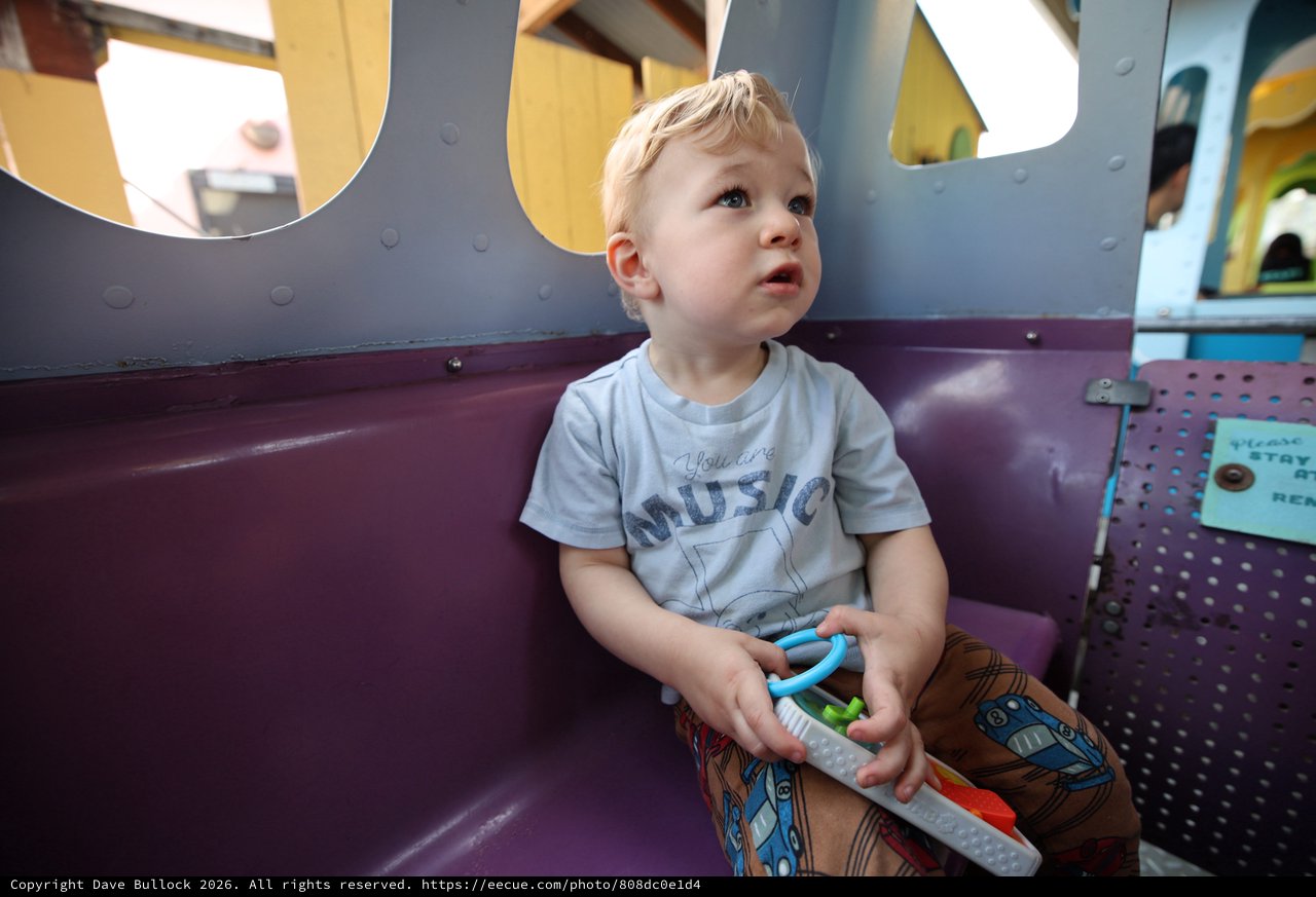 Young Child Gazing Upward in Colorful Play Area