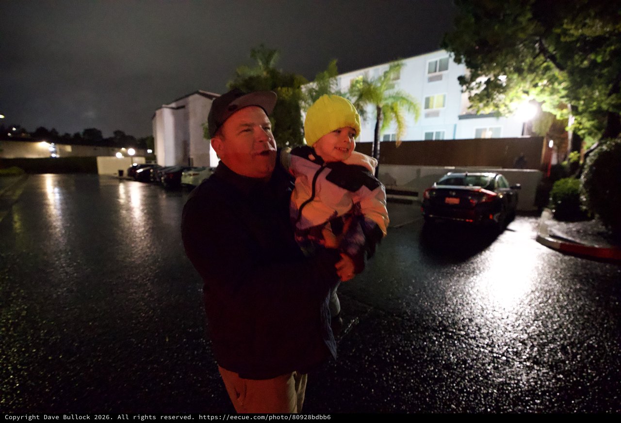 Father and Child During Nighttime Flood Emergency Evacuation