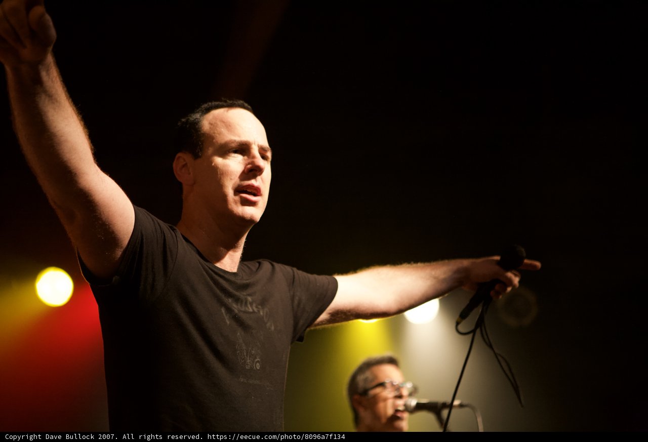 Entertainer in the Spotlight Caption: A singer commands the crowd with two microphones in hand during a solo performance at a Bad Religion concert in 2007.