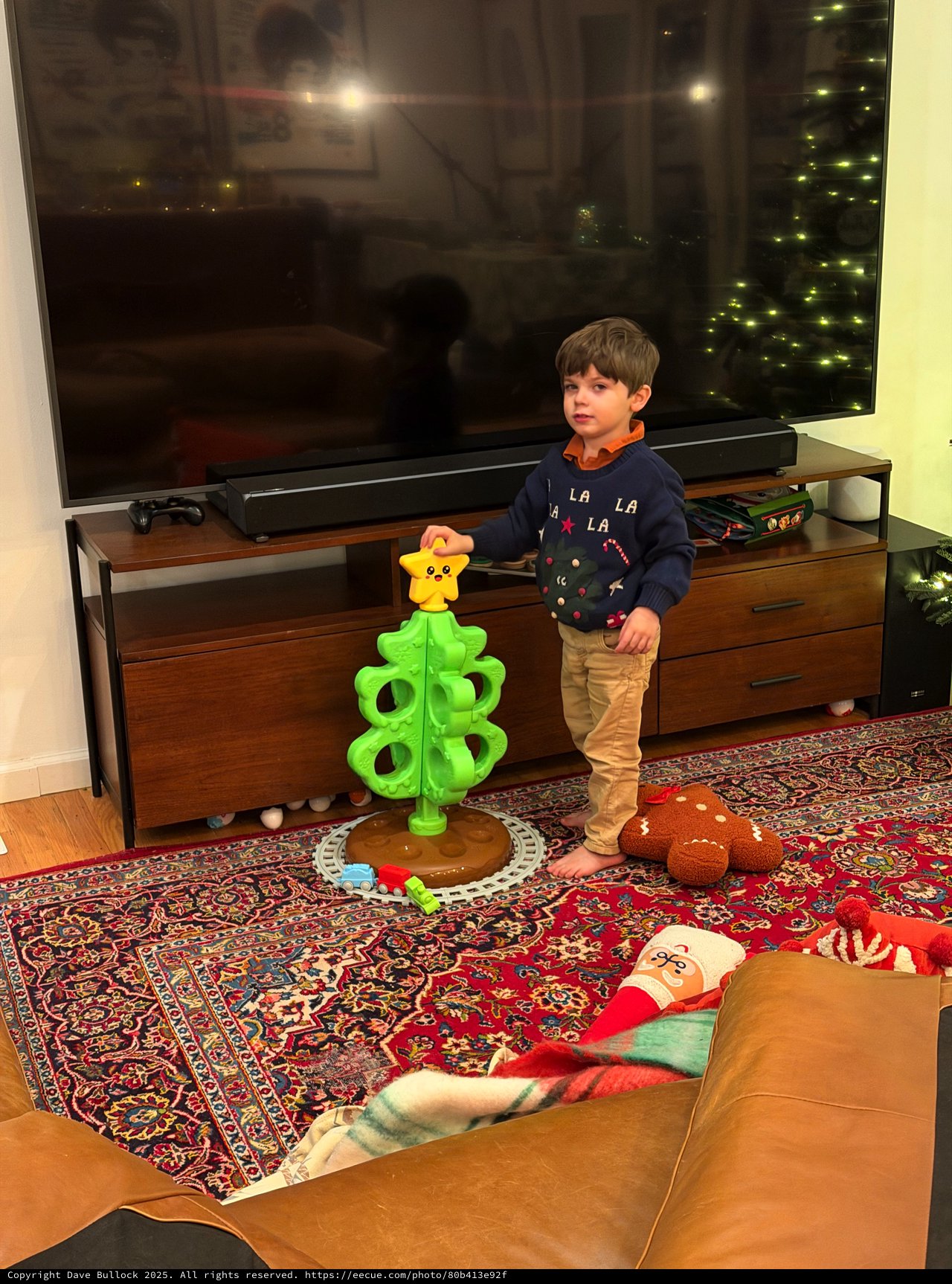 Young Boy Playing with Bright Green Toy Tower