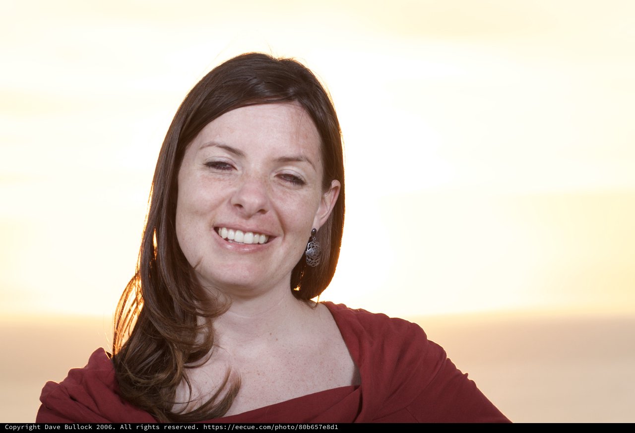 Radiant Woman Smiling at Golden Hour Sunset