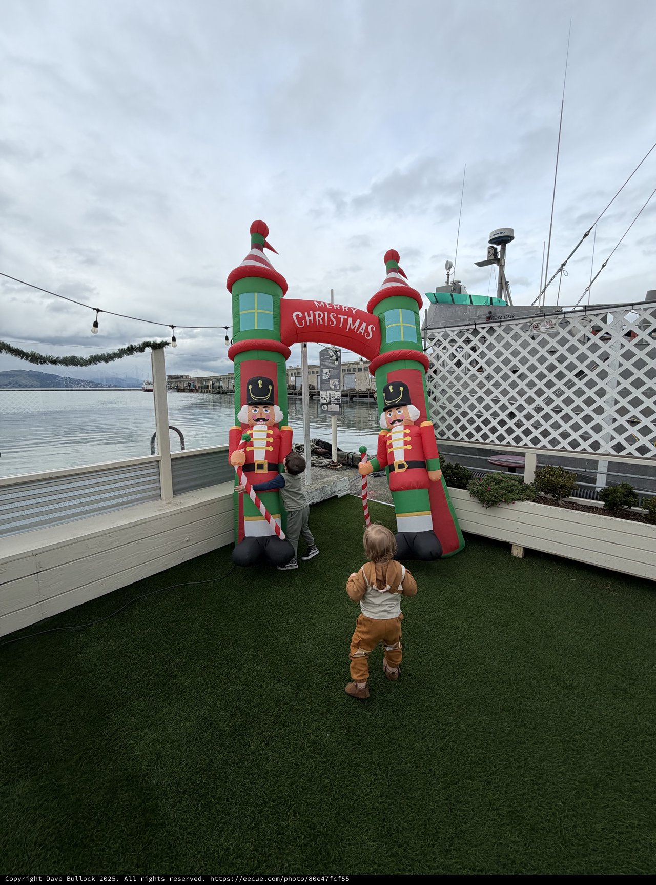 Children Exploring Inflatable Christmas Display by the Waterfront