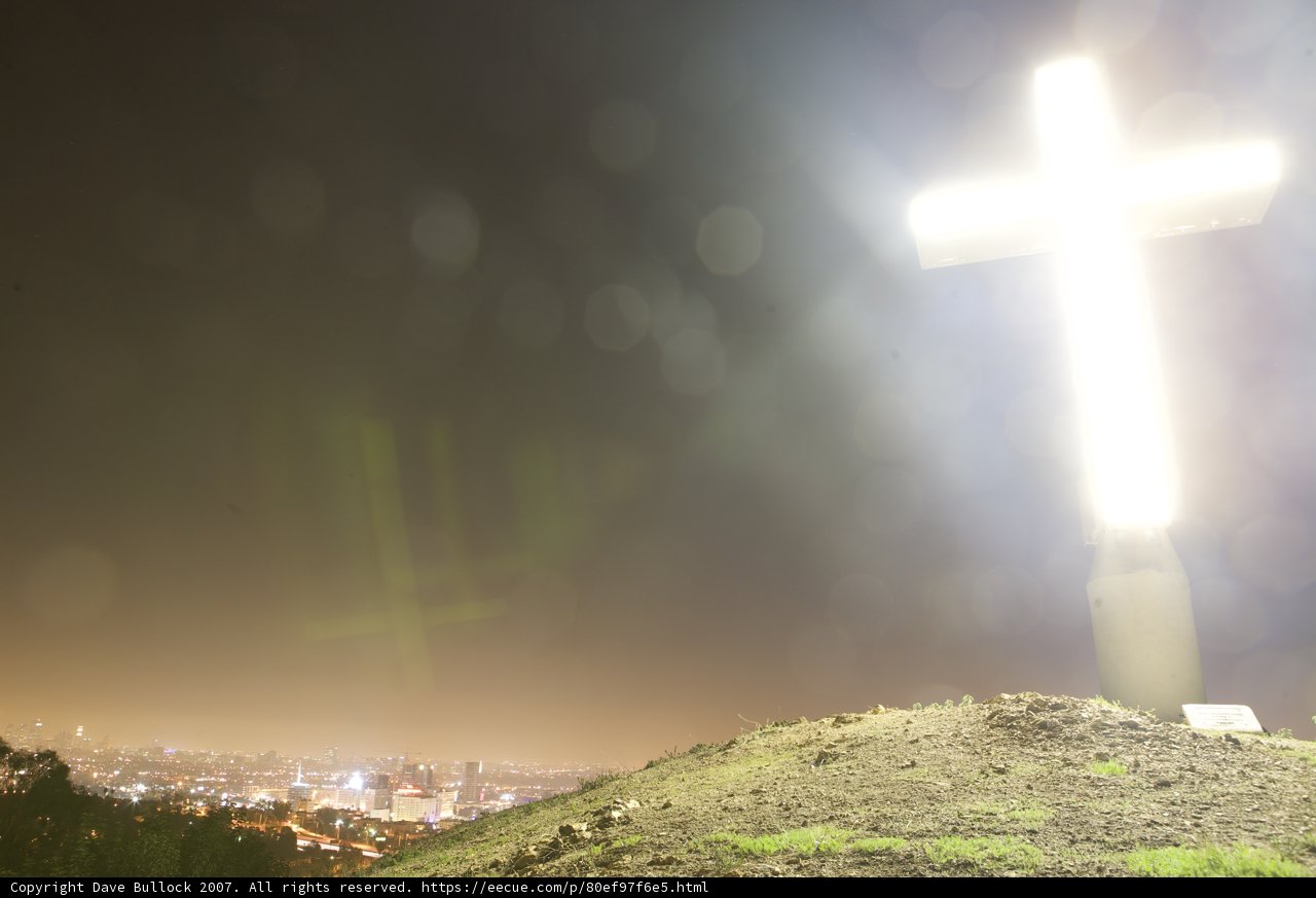 Cross atop the hill under the night sky