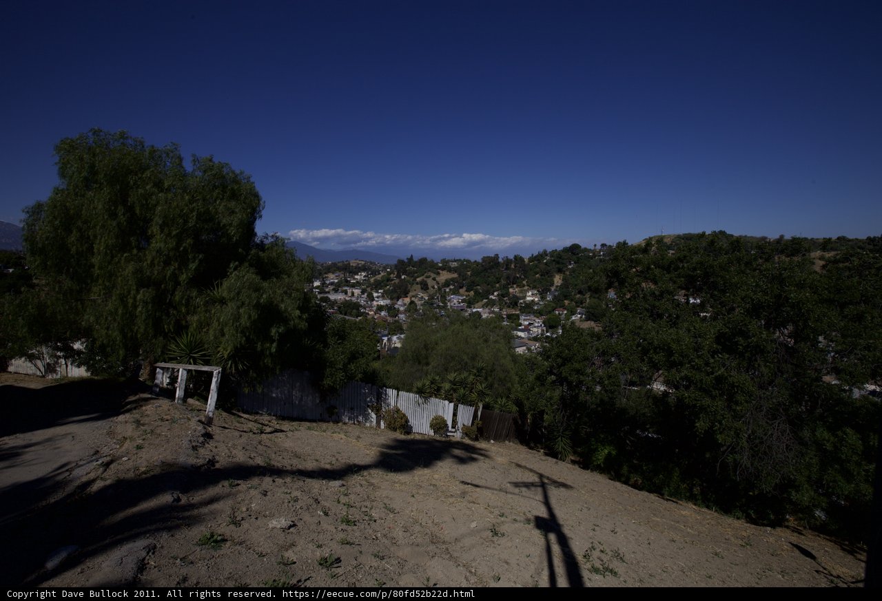 Scenic View of Mountains and Houses from a Hill