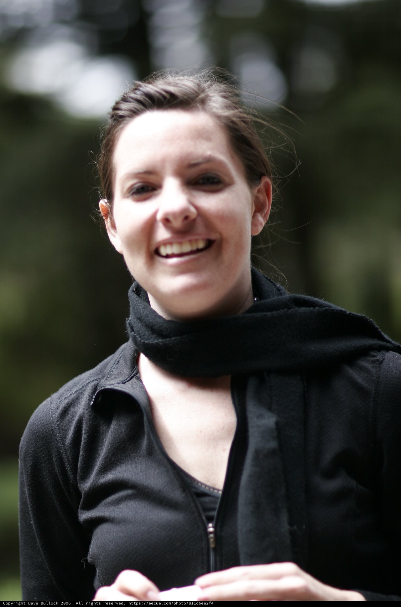 Smiling Young Woman in Black Outdoors Portrait