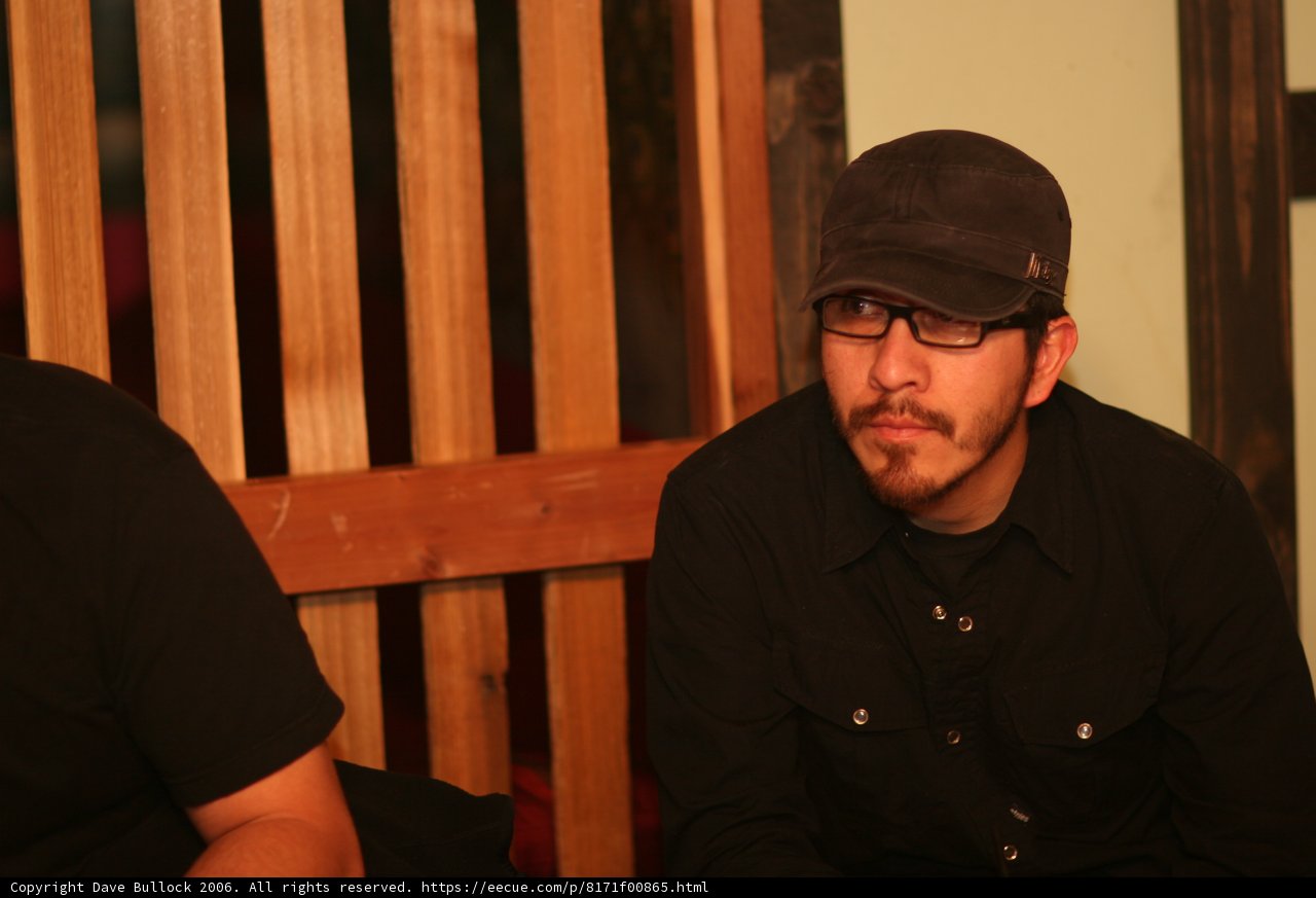 Gil M in His Signature Black Shirt and Hat