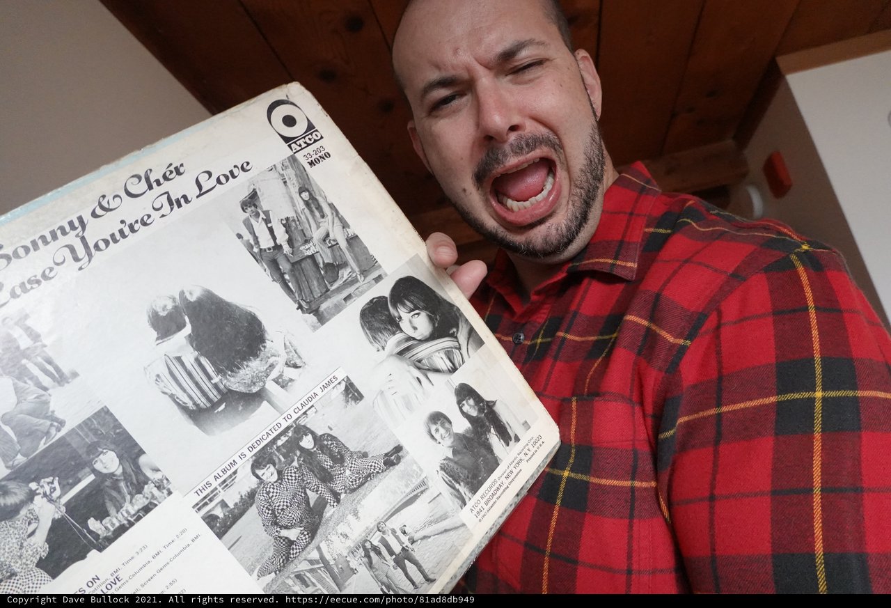 Excited Man Shows Off Vintage Record Album