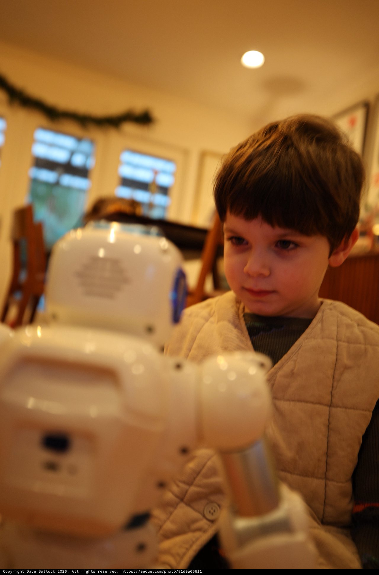 Young Boy Building White Robotic Toy at Home
