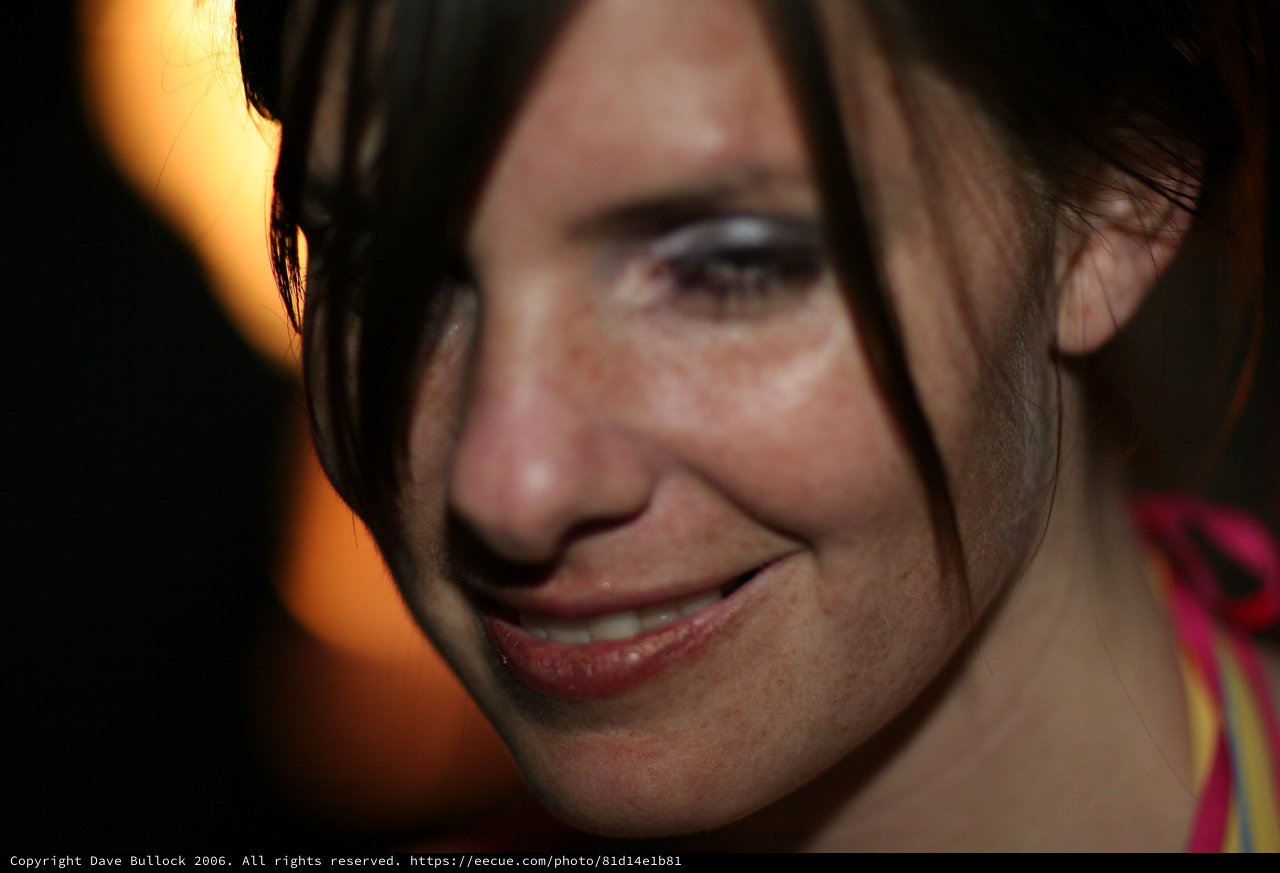 Candid Close-Up Portrait of Smiling Woman at Night