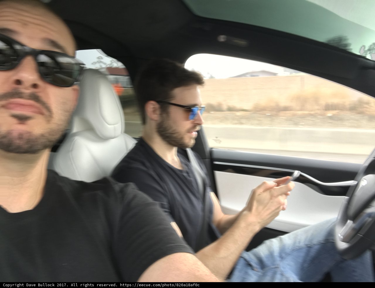 Two Men Multi-tasking while Driving