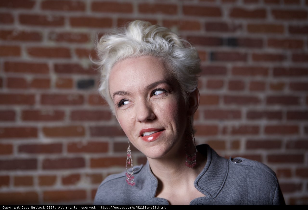 Smiling Lady in Gray Shirt Poses for Portrait
