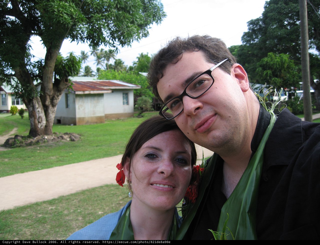 Couple Posing with Floral Leis in Fiji Village