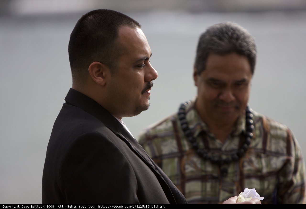 Two Men in Suits Holding Flower Arrangement