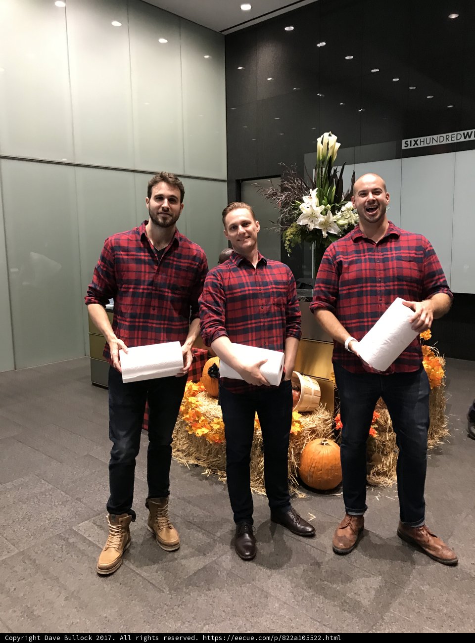 Three Men with Boxes and a Flower Arrangement