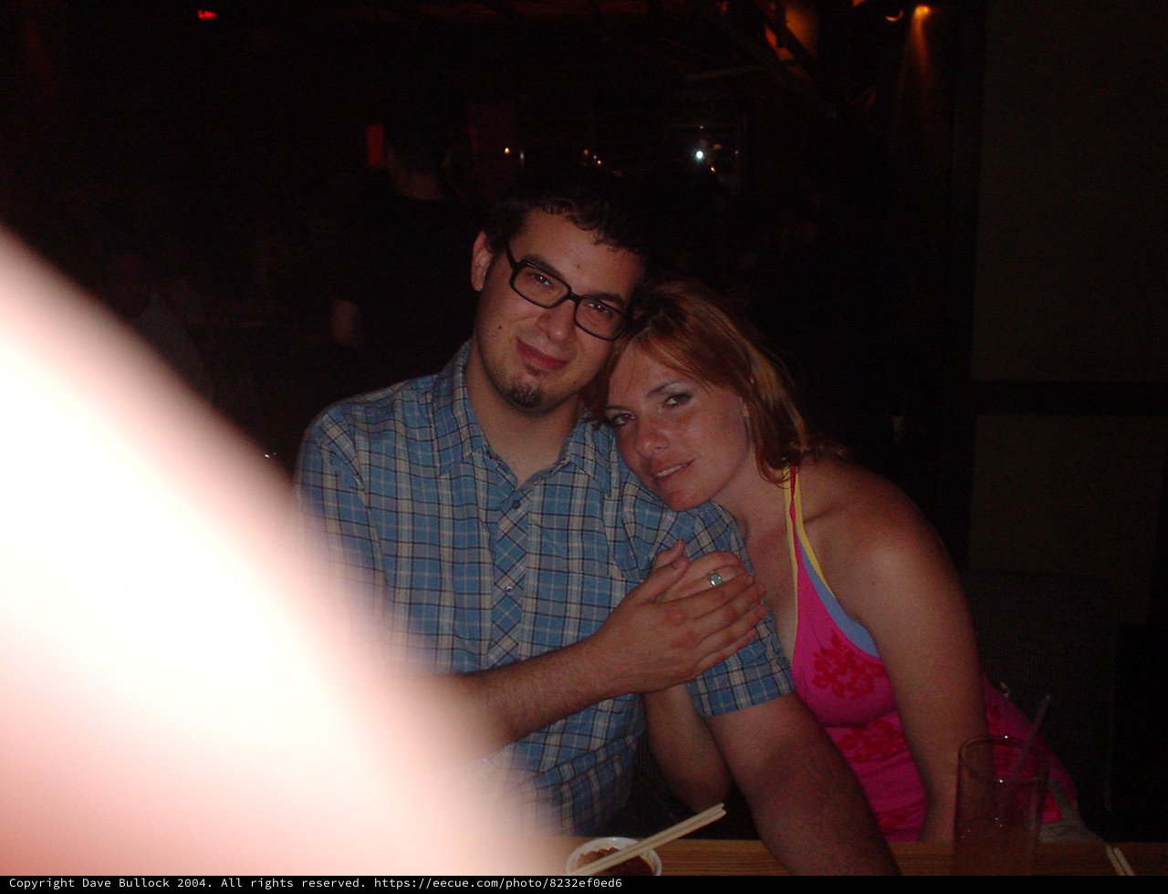 Couple Sharing a Close Moment at Dimly Lit Restaurant