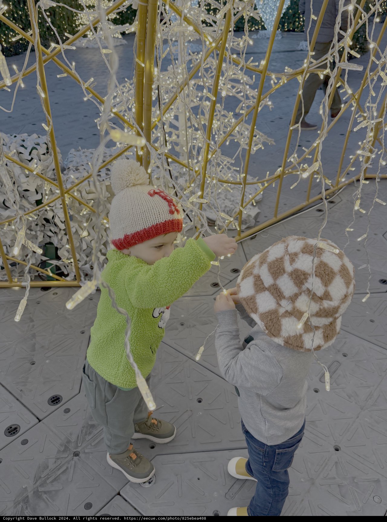 Children Playing Under Illuminated Winter Decorations