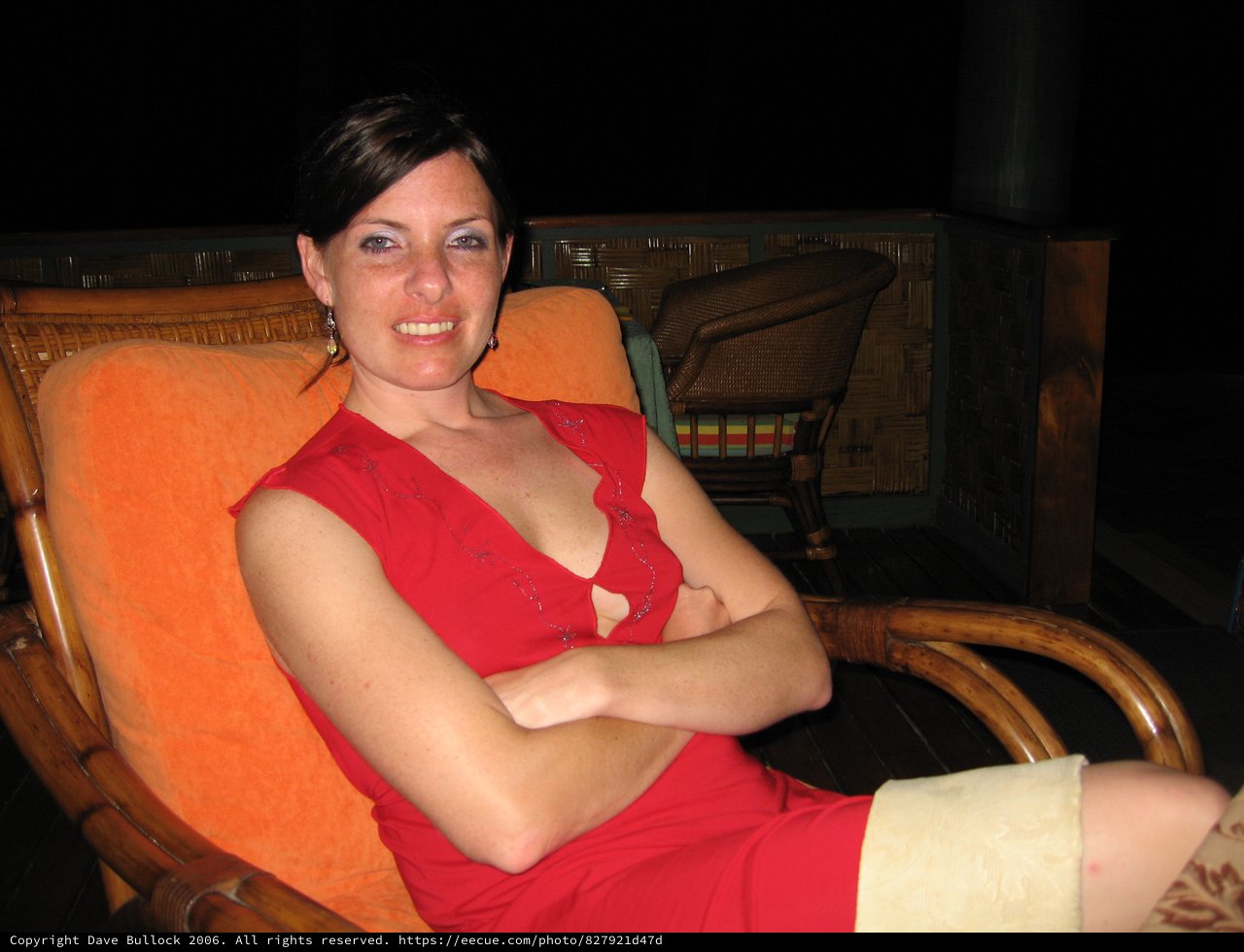Woman in Red Relaxing in Wicker Chair