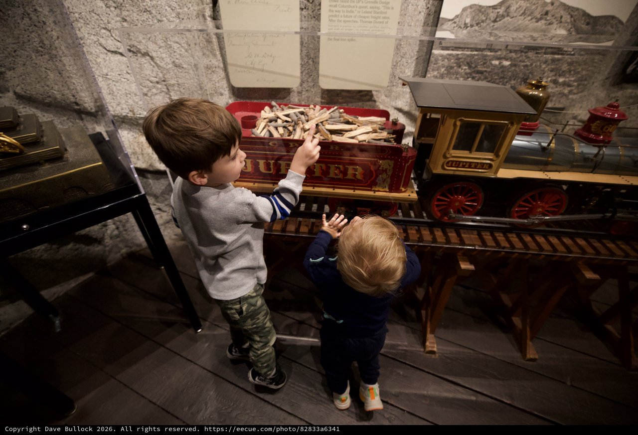 Children Exploring Historic Train Exhibit at Museum