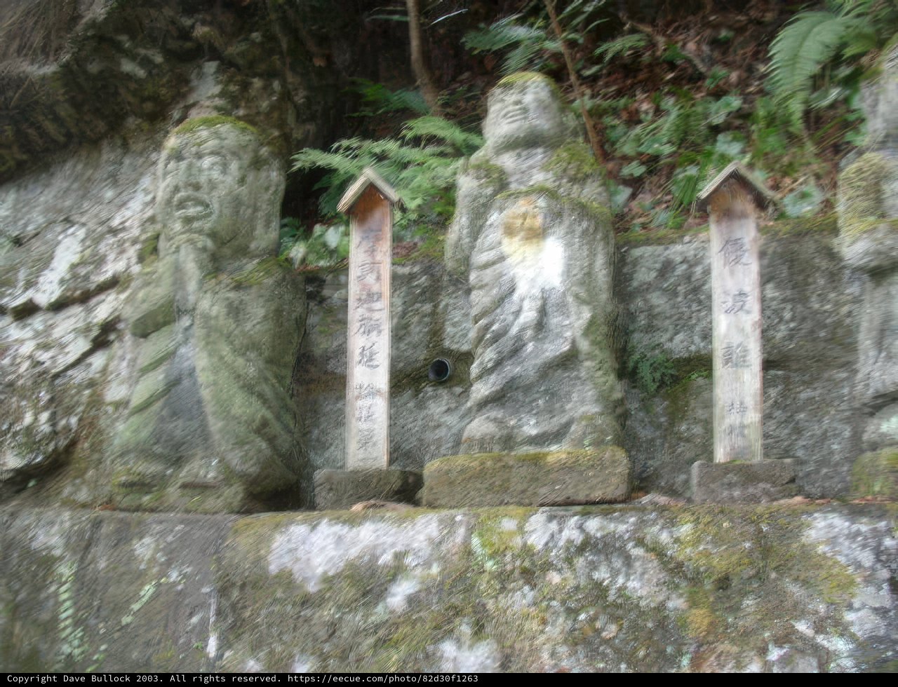 Statues of Buddhas on a Rock Wall