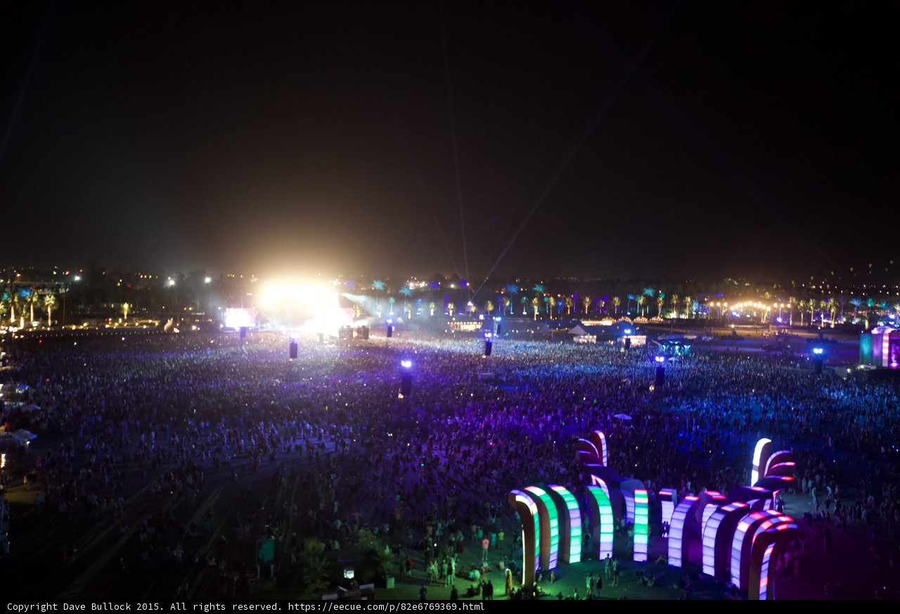 Nighttime Fireworks Over a Crowded Festival