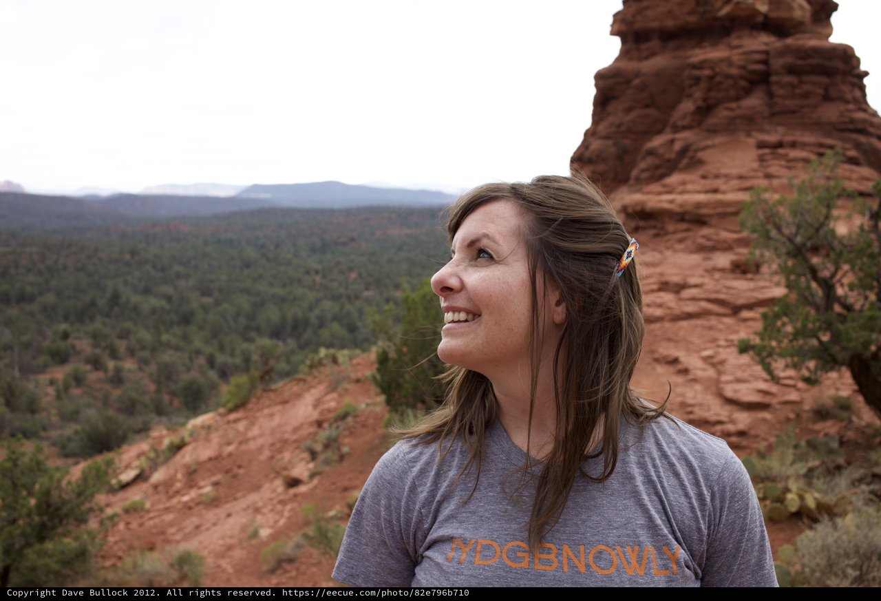 Woman Gazing Upward at Sedona Red Rock Formation