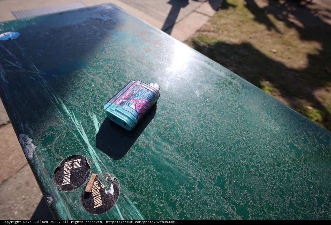 Crushed Beer Can on Worn Green Ping Pong Table