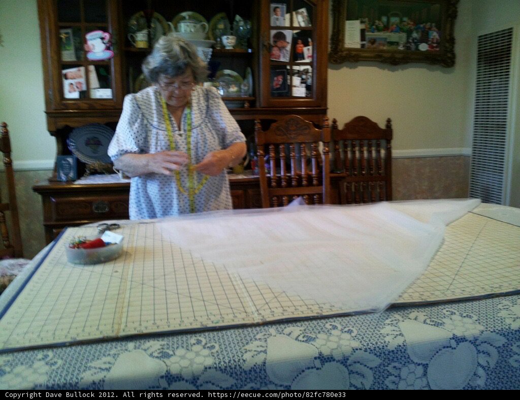 The Art of Linen: A Woman Cuts a Tablecloth
