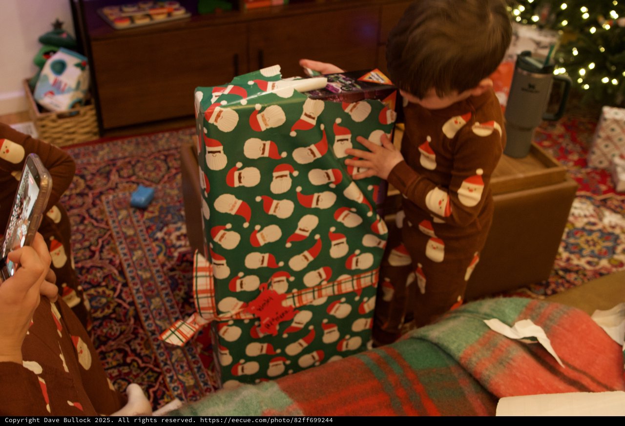 Child Opening Large Christmas Gift on Holiday Morning