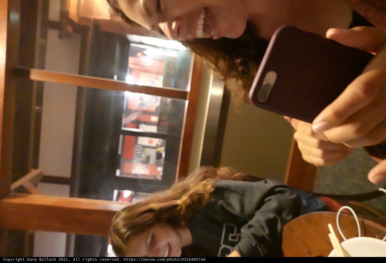 Friends Sharing a Moment on Their Phones