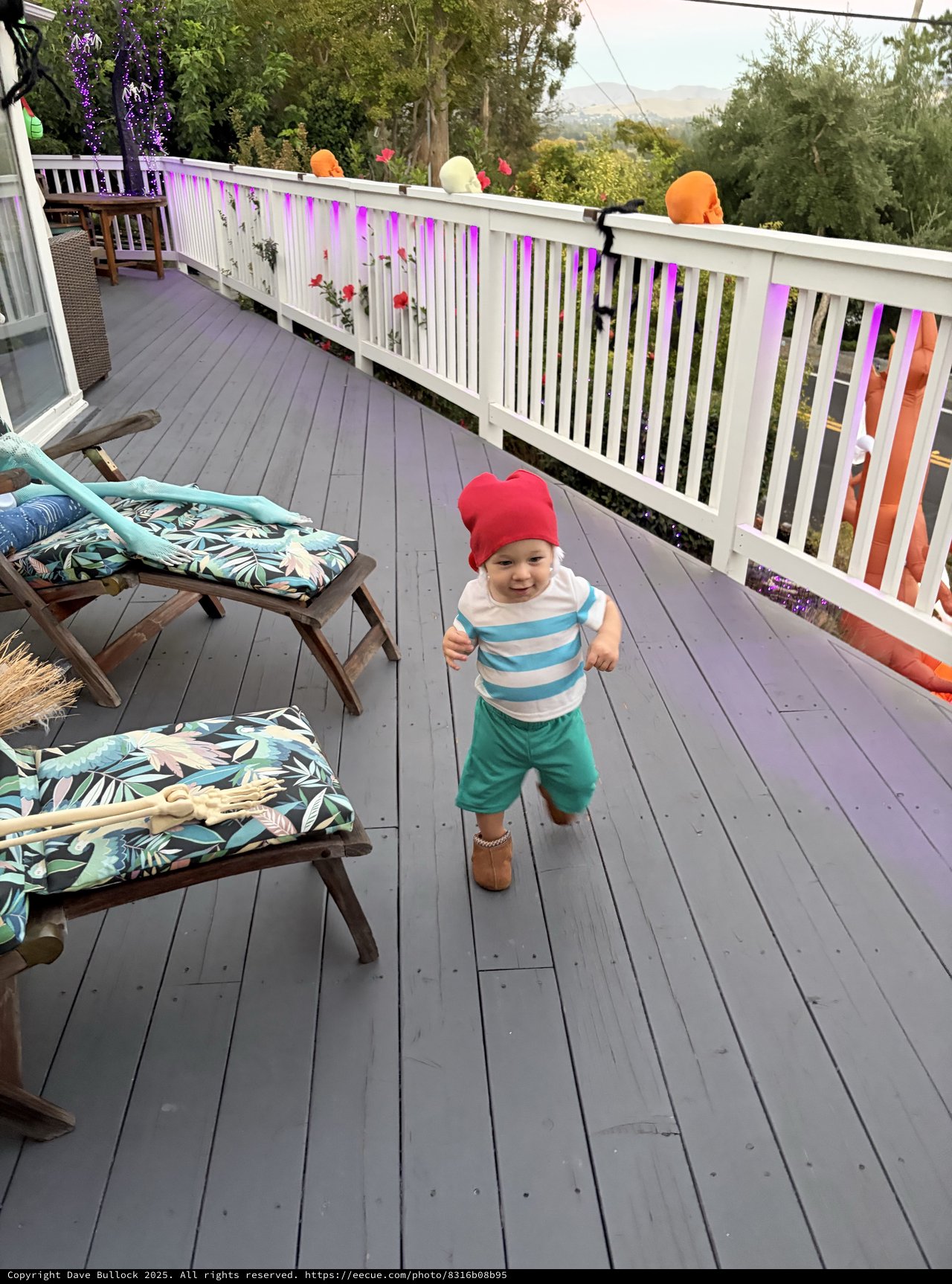 Joyful Toddler Running on Decorated Deck