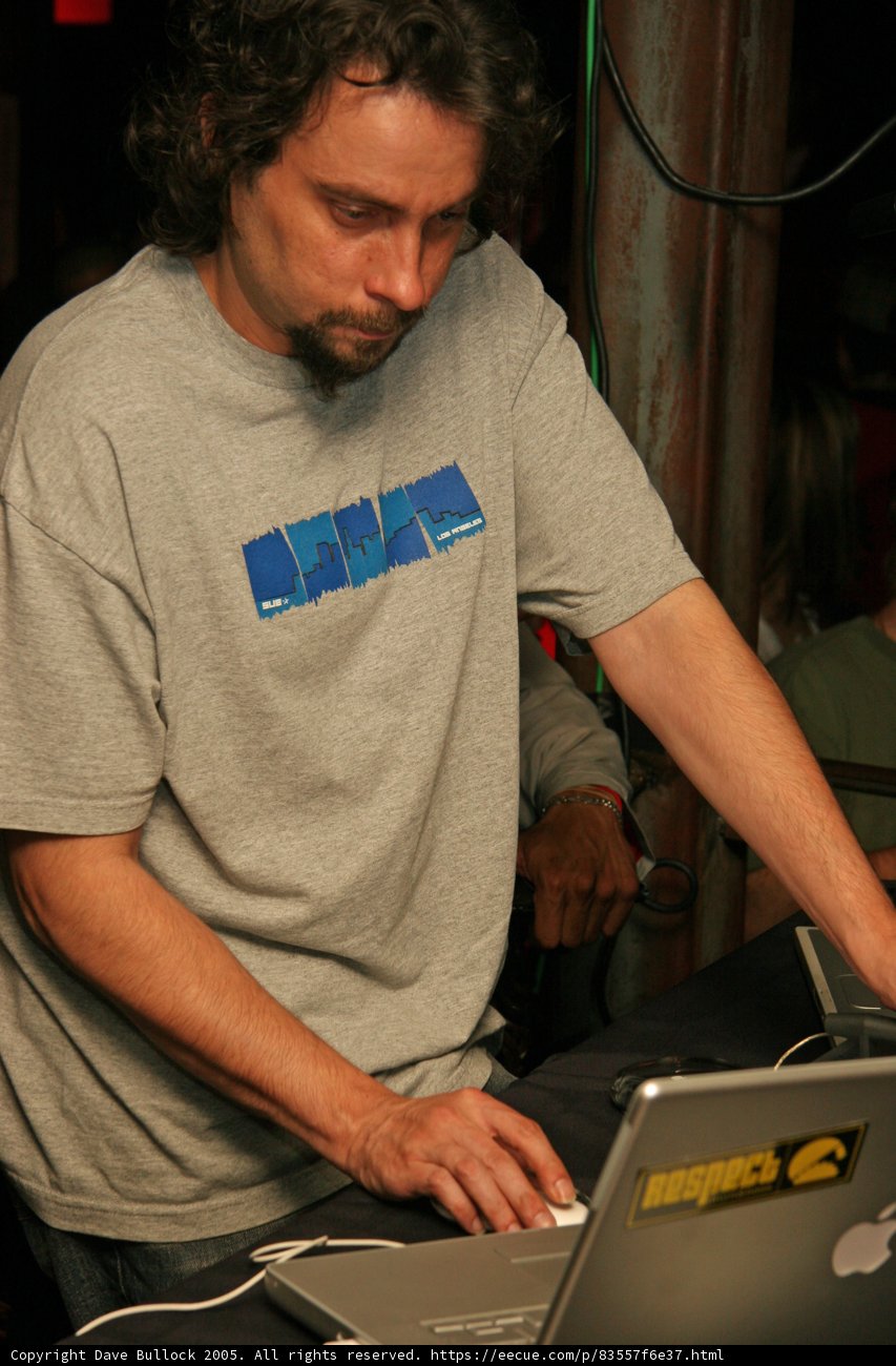 Grey Shirted Man Working on Two Laptops