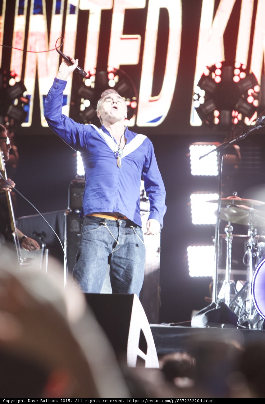 Morrissey Arm Raised Mic High Looking Up Blue Shirt Open Drums LED Head UNITED KINGDOM Screen