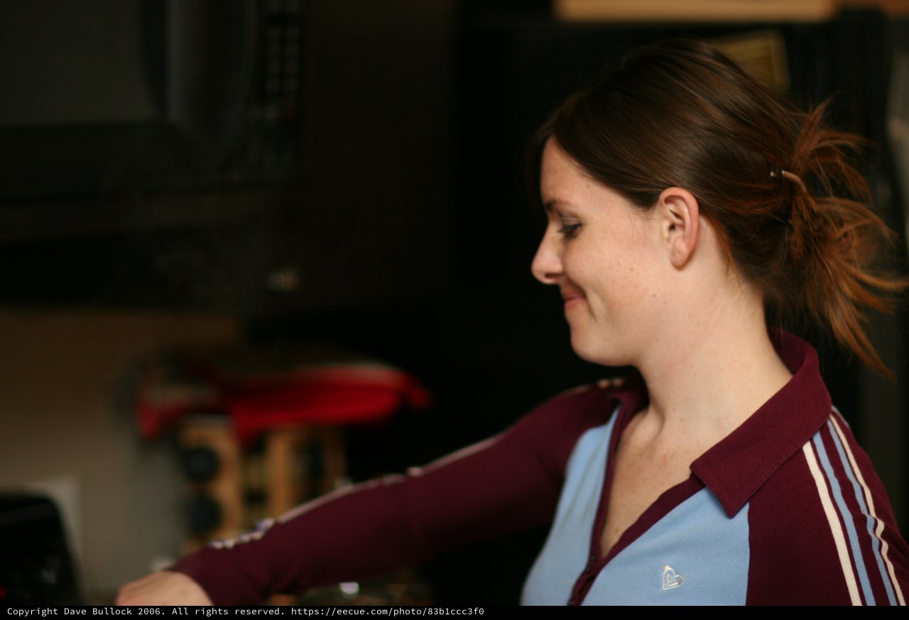Woman in Profile Smiling Indoors at Night